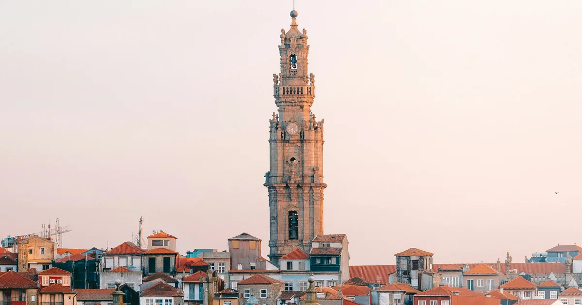 Clérigos Tower rising above the rooftops of Porto at sunset