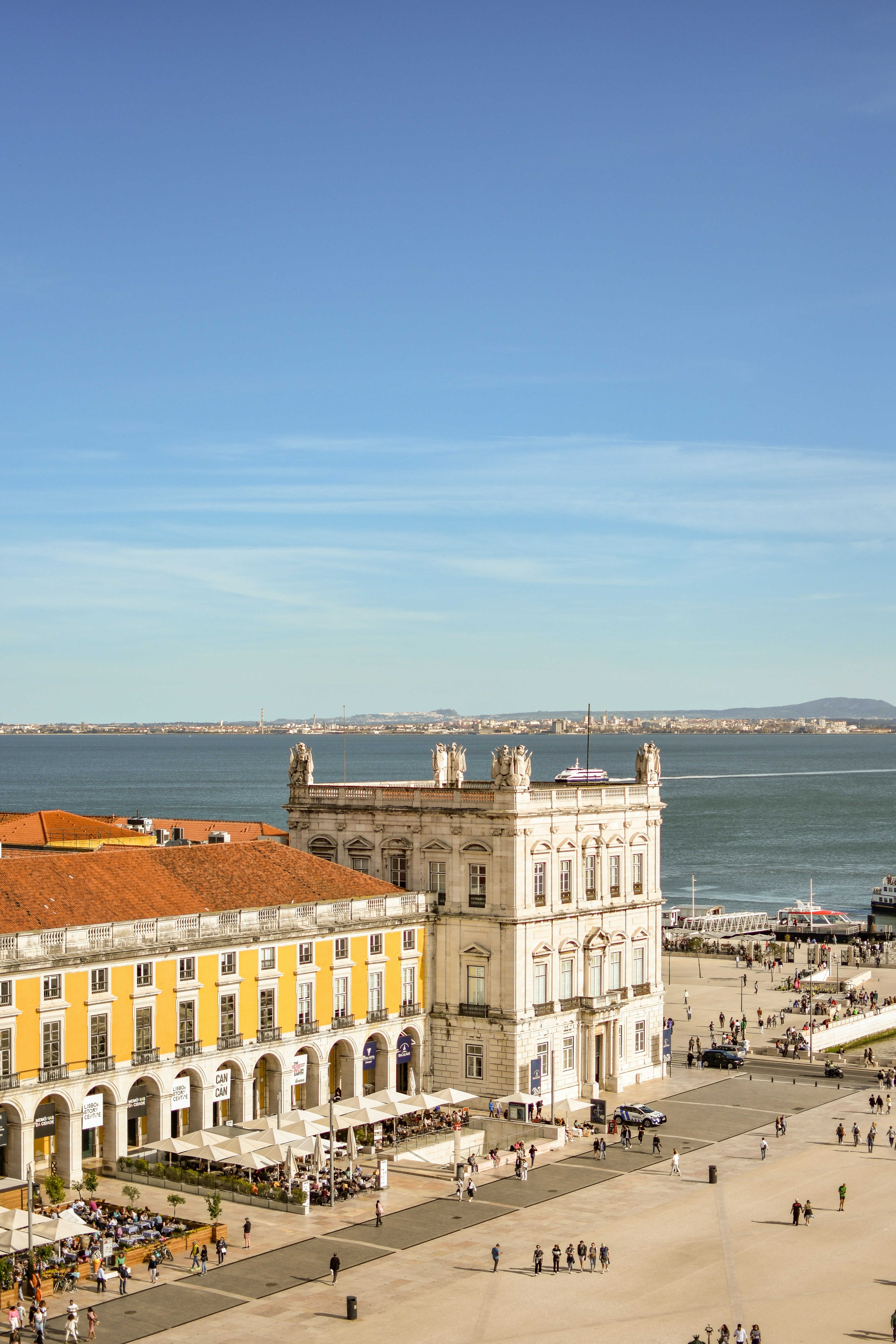 Praça do Comércio in Lisbon, with yellow arcades and a white riverside palace facing the Tagus